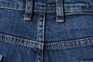 Fototapeta premium Straps for a belt in blue jeans. Back view