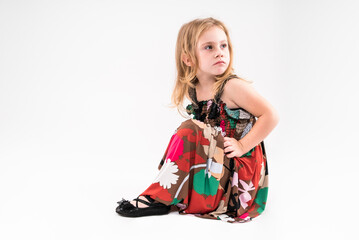 Little girl posing on a light background