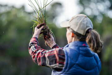 young Female soil scientist holding a soil in a hand in a soil laboratory in australia