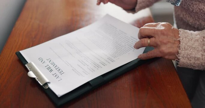 Senior woman, hands and writing will, documents or testament in retirement or life insurance on desk. Closeup of elderly female person reading or filling paperwork, form or legal application on table