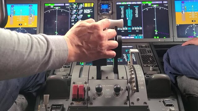 Hand held shot of Male hand on throttles while running the engines of a 787 commercial passenger airplane.