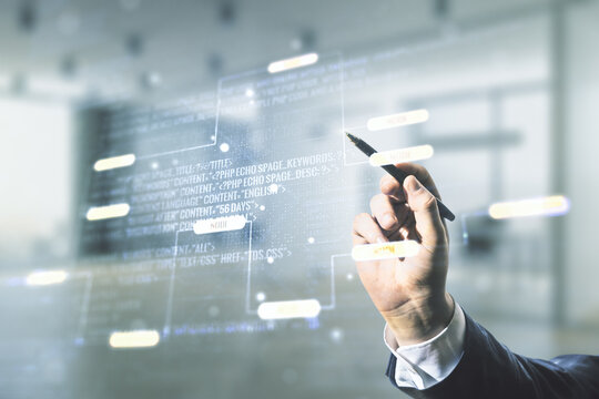 Double exposure of programmer's hand with pen working with abstract creative programming illustration on blurred office background, big data and blockchain concept