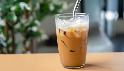 Iced caramel macchiato coffee in glass with stainless steel straw for drink. Concept for reduce plastic pollution and support green eco friendly products. selective focus