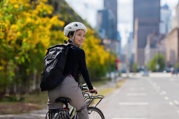 Asian woman rides her bike to work on a nice day