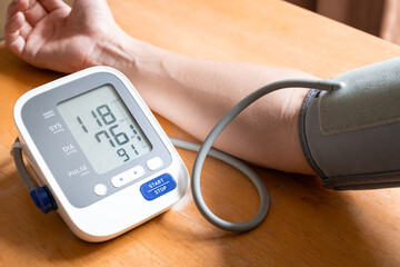 Man check blood pressure monitor and heart rate monitor with digital pressure gauge. Health care...