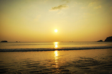 Tropical sea beach in summer time on sunny day. Golden sand beach sea peaceful scenery on the beach. Travel vacation seaside outdoor. Ocean island beautiful dramatic landscape. Sunny seascape scene.