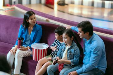Families are using movie tickets to check and chat before going in.