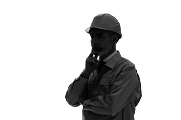 Silhouette of a thoughtful elderly Caucasian worker in work clothes.