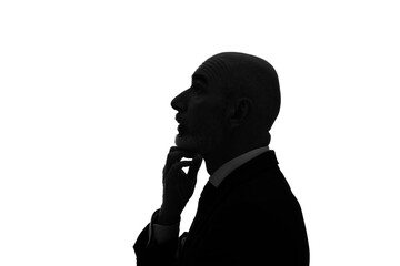 Silhouette of thoughtful elderly caucasian businessman.