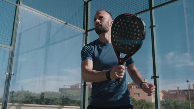 Padel tennis player does a drive shot.