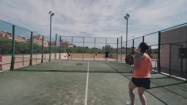 Padel tennis match. Service, lob shot and smash.