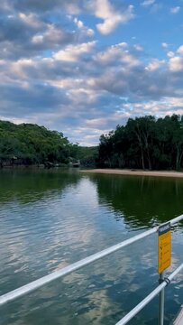 4k Video -Panning around at sunset from the new pontoon at Wattamolla Beach in Royal National Park, Australia, home to a beautiful lagoon, a secluded beach, a pretty waterfall, and a large picnic area