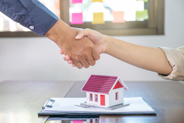 Real estate agents and buyers handshake after signing a business contract, renting, buying, mortgage, loan or home insurance