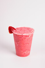 Refreshing strawberry fruit iced soft smoothie in a transparent glass in white background