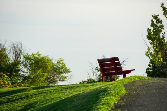 Red park bench on hill