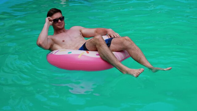 Water fun in sunny summer day. Summertime vaction man in pool having fun.