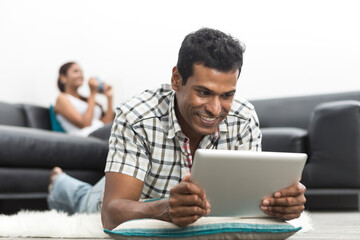 happy Indian man using Digital Tablet