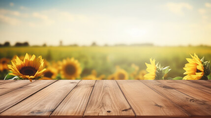 Wooden table top with blur background of sunflower field
