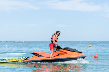 Lifeguard driving a Jet ski on duty on the sea