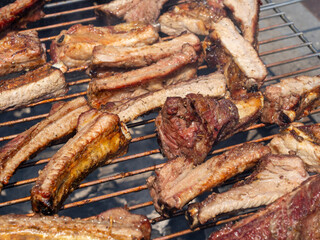 Roasted Juicy spare ribs cooked over the coals on a barbecue. Summer and holiday time. Delicious food