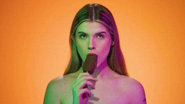 Young Sexy Caucasian Naked Blonde Lady Eats Ice Cream Chroma Background with Sensual Gesture, Portrait Shot