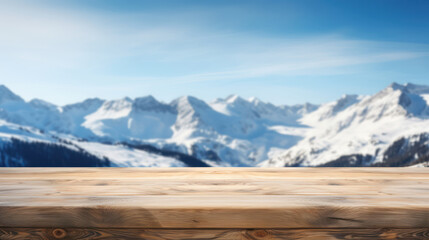 Empty wooden table top with blur background of snow capped mountains
