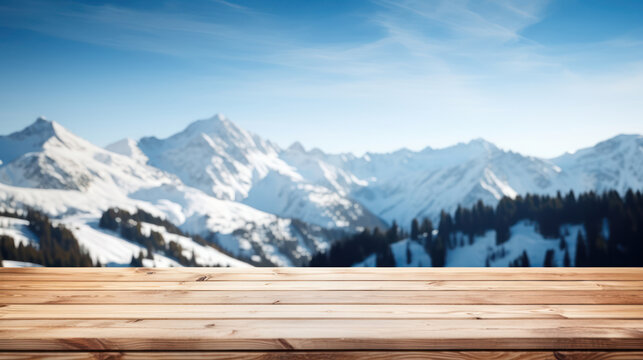 Empty wooden table top with blur background of snow capped mountains
