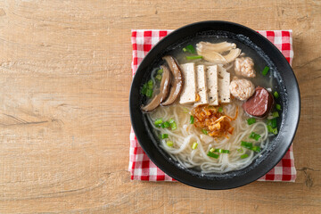 Vietnamese Rice Noodles Soup with Vietnamese Sausage served vegetables and crispy onion