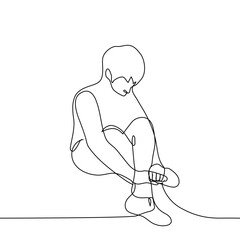 man sitting hugging his legs - one line art vector. the concept of sitting on the floor in embarrassment, alone