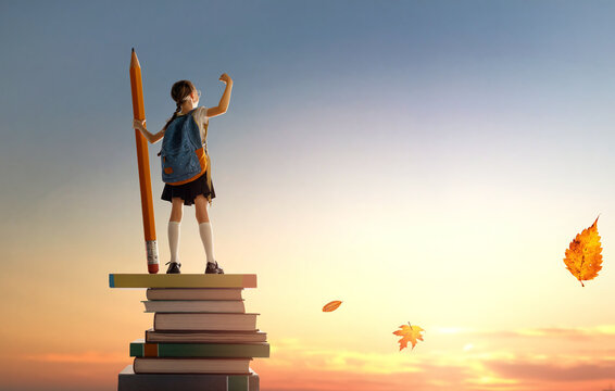 child on the tower of books