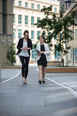 Two happy businesswomen talking