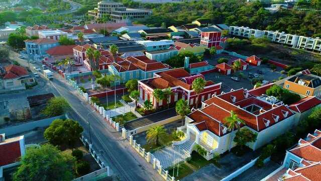 Homes and official buildings in Willemstad curacao illuminated by sunrise golden hour