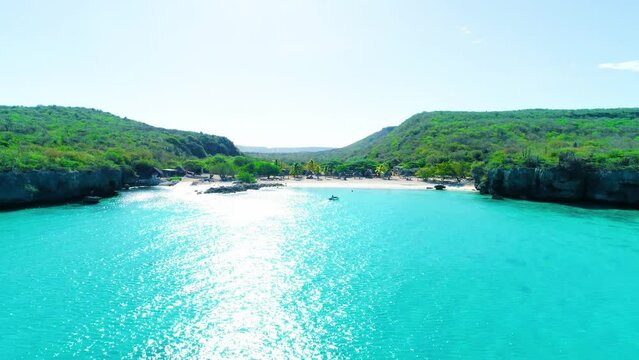 Drone dolly to turquoise water of curacao and pristine hidden beach cove getaway