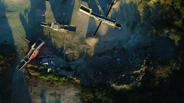 Top down bird's eye view of linear overpile reclaiming machine piles and long shadows