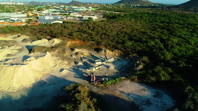 Drone orbit around linear overpile portal reclaiming heavy machinery in industrial zone