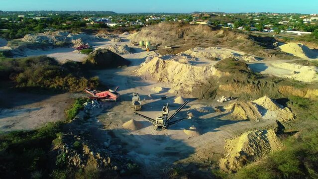 Drone rise and tilt down above fill piles for construction projects, town outskirts