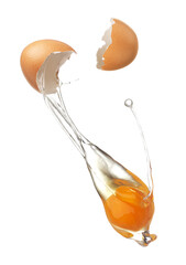 Cracked egg shell revealing egg yolk and white
