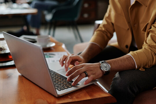 Businessman Working On Laptop In Cafe