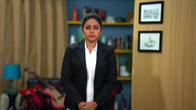 An Asian Young Empowered Woman stands tall in her office, though her demeanor reflects a mix of unhappiness and resentment, fueling her determination to overcome challenges and carve her path.