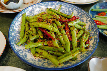 Close up dish of stir fry green bush beans with minced pork