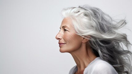 Portrait of a beautiful elderly woman on a light background