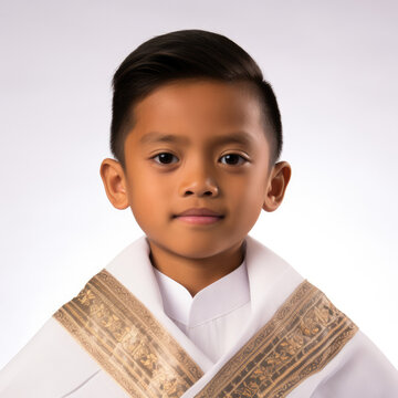 Studio shot of a Filipino 8-year-old boy wearing a traditional barong Tagalog.
