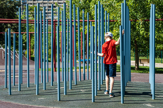 Boy playing in a playground in summer, Georgia