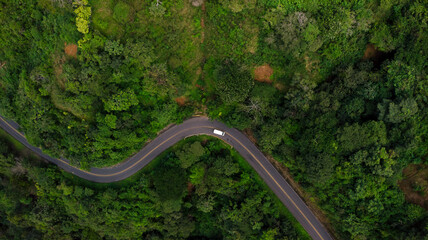 Top-down photograph of a road with car