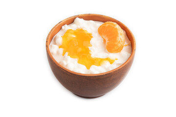 Grained cottage cheese with tangerine jam isolated on white, side view.