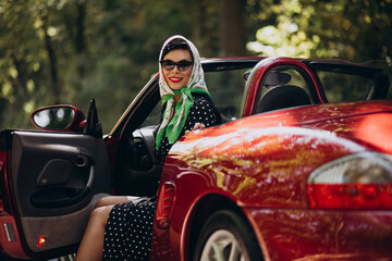 Beautiful woman driving red cabrio