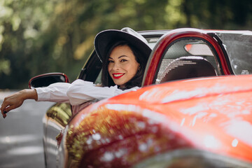 Beautiful woman driving red cabrio