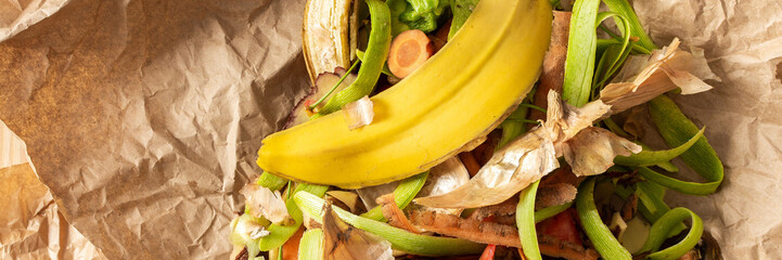 Food organic waste on eco friendly parchment paper, fruit and vegetable peel, garbage sorting and recycling banner