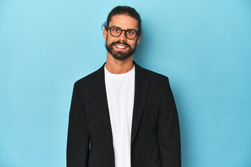 Businessman in suit with eyeglasses and beard happy, smiling and cheerful.