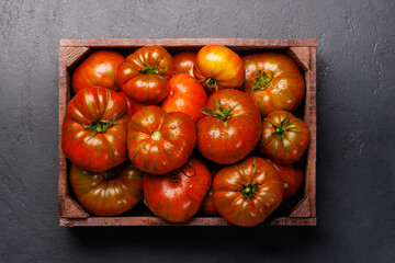 Assorted tomatoes in rustic crate
